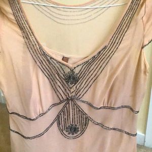 Sheer pink top, camisole, sequin stitching.